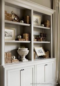 a white bookcase filled with lots of books