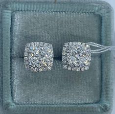 Beautiful Diamond Stud Earrings White Gold.  These cushion shape diamond studs are unique than your round studs.  Excellent craftsmanship and diamond quality, these sparkles beautifully on the ear.  Just the right size to wear all the time.  The center cluster of diamonds are set with minimal prongs showing for the big wow factor.  Love love the sparkles of these stunning earrings.  The center diamonds are good sizes, so it really sparkles tons.  The strong push backings have two security notches for a secure fit.  Measures 9.1mm.  I'm proud to attach my name to these gorgeous earrings.  Genuine earth mined round brilliant cut diamonds  Total weight: 1.42 Carats Clarity: SI Color: F Solid 18K White Gold 2.79 grams  Comes with gift box #3310A * We have been in the wholesale Jewelry business Earrings Diamond Studs, Square Diamond Earrings, Stud Earrings Diamond, Earrings White Gold, Earrings Diamond, Square Diamond, Earrings White, Diamond Stud Earrings, Stunning Earrings