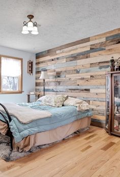 a bed room with a neatly made bed and wooden walls