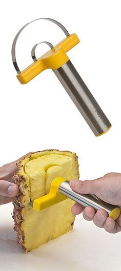 a piece of pineapple being cut with a knife and tongs by a person using a fruit slicer