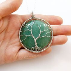 Green Aventurine Tree of Life Necklace / August Birthstone / Silver Wire Wrapped Tree Pendant / Gift for Mom / Gift for Wife / Family Tree Jewelry This tree of life pendant necklace is one of a kind and handmade with a beautiful green aventurine stone wrapped with lovely silver jewelry wire. It hangs on a delicate yet sturdy 2mm silver plated cable chain necklace. The pendant measures around 2.25 inches long by 1.75 inches wide. Necklace lengths are available from 16 inches to 24 inches long. ~ Aventurine Gemstone Bead Pendant Jewelry, Aventurine Gemstone Beads Jewelry As Gift, Aventurine Gemstone Beads Jewelry For Gift, Bohemian Round Aventurine Jewelry, Aventurine Jewelry With Natural Stones In Round Pendant, Healing Aventurine Round Pendant Jewelry, Aventurine Jewelry Gift, Round Aventurine Jewelry Gift, Handmade Aventurine Pendant Jewelry