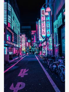 a city street at night with neon signs on buildings and bicycles parked along the side