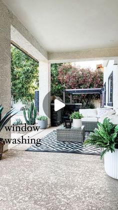 a living room filled with furniture and plants next to an open patio door that says window washing