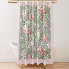 a shower curtain with pink and green flowers on it, next to a bathtub