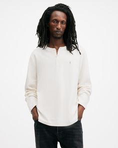 An easy essential? This is it. The Rowe is a long-sleeve henley shirt made from organic cotton with a waffle texture that's super soft to touch. Complete with flatlock stitching and our signature Ramskull embroidery, it's the perfect piece for casual days.  This henley is designed to a regular fit that is true to size Three button placket Long sleeve Waffle fabric with a soft handfeel Ramskull embroidery Flatlock stitching Cotton Long Sleeve Henley For Loungewear, Spring Henley Crew Neck For Everyday Wear, Spring Crew Neck Henley For Everyday, Everyday Spring Henley With Crew Neck, White Cotton Henley For Fall, Spring Everyday Henley With Crew Neck, Spring Crew Neck Henley With Relaxed Fit, Spring Henley With Relaxed Fit And Crew Neck, Spring Relaxed Fit Henley With Crew Neck