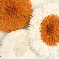 three orange and white pillows on top of each other in the shape of circles,