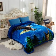 an eagle is flying through the night sky on a blue comforter set with matching pillows