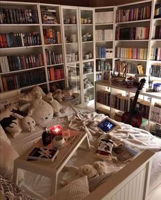 a bedroom with bookshelves and stuffed animals on the bed