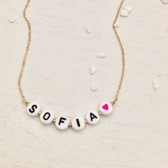 Fashion should be fun because life is just too short for boring. Our Alphabet Bead Necklaces are just so adorable. Perfect for layering with a couple of your other favorite necklaces. There's no age limit for these super cute necklaces! Wear your favorite people's names, short sayings or cute message. Max of 10 letter/heart characters for each necklace. Add a colorful heart bead for fun and get creative! Enter in special instructions for the design of your necklace in the instruction box. Chain Alphabet Beads Necklace, Letter Bead Necklace, Short Sayings, Cute Necklaces, Cute Message, Puffy Heart Charms, Alphabet Necklace, Diamond Initial Necklace, Beaded Necklace Designs