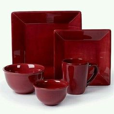 a red dinnerware set with matching cups and saucers is displayed on a white background