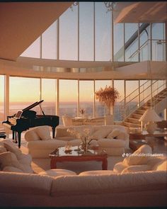 a living room filled with furniture and a grand piano