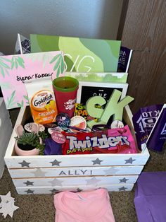 a box filled with lots of assorted items on top of a carpeted floor