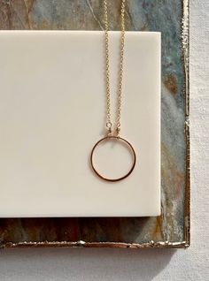 The simple circle necklace can be worn on its own or layered with your favorite pieces. Available in both sterling silver and 14k gold fill. The circle pendant measures approximately 1 inch or 20mm in diameter.  This piece coordinates well with so many other pieces in my shop! Everyday 14k Gold Full Circle Jewelry, Everyday Full Circle 14k Gold Jewelry, Everyday Sterling Silver Round Charm Necklaces, Everyday Round Sterling Silver Charm Necklace, Minimalist Yellow Gold Open Circle Necklace, Everyday Circular Yellow Gold Necklace, Everyday Yellow Gold Circular Necklace, Everyday 14k Gold Open Circle Jewelry, Simple Round Pendant Charm Necklace For Everyday