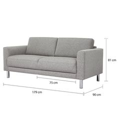 a gray couch sitting on top of a white floor next to a measuring line with measurements