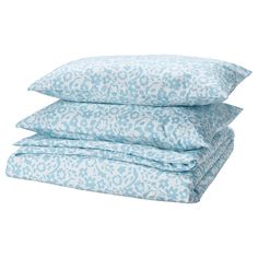 three pillows stacked on top of each other in blue and white leopard print, with the covers folded down