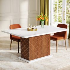 a dining room table with two chairs and a vase on it