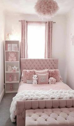 a pink and white bedroom with a bed, window, bookcases and stuffed animals