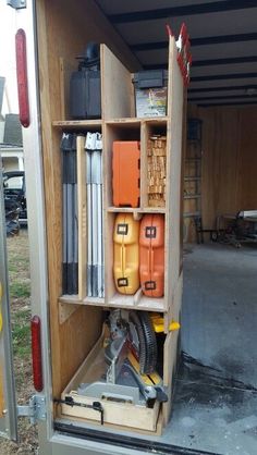 the inside of a moving truck with tools in it's storage compartment and shelves