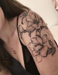 a woman with a flower tattoo on her arm