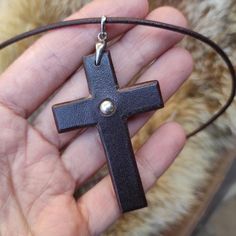 Leather Cross with a silver ballNecklace accessory made of genuine leather.Please choose from the three available colors - brown, black, tobacco.he lace is made of genuine leather and has a silver fasteningDimension:thickness 0,1''height 2,3''width 1,1'' Brown Crucifix Cross Necklace As Gift, Handmade Brown Cross Jewelry, Adjustable Brown Cross Necklace, Adjustable Brown Cross Pendant Necklace, Handmade Brown Cross Pendant Necklace, Handmade Brown Cross Necklace, Diy Leather Wallet, Silver Ball Necklace, Cross Shape