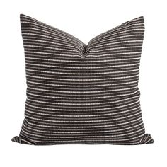 a black and white striped pillow on a white background