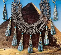 "These turquoise pressed glass Pharaohs were originally used by the Whiting Davis company in the 1950s. I have wrapped them in antique gold toned filigree, and used a vintage chain bib necklace which is adjustable in length. Earrings can be converted to posts, or clip ons, just ask ! My work has been sold at the Field Museum in Chicago during their Tut exhibit.                                                                             CONDITION - repurposed vintage & antique components have patina, and charm MEASUREMENTS - Necklace is 17.5\" - 20\" long, drops are 2\" long FABRIC/MATERIAL (s) :  Brass, Czech glass, vintage stones and chains                                           1950s Whiting Davis pressed glass Pharaohs                                           Most of my components a Ornate Turquoise Jewelry For Collectors, Ornate Handmade Turquoise Jewelry, Antique Blue Jewelry With Patina, Antique Blue Patina Jewelry, Vintage Blue Ceremonial Jewelry, Antique Handmade Blue Turquoise Necklace, Handmade Antique Blue Turquoise Necklace, Unique Blue Etched Jewelry, Unique Etched Blue Jewelry