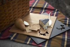 an assortment of cheese and crackers on a cutting board