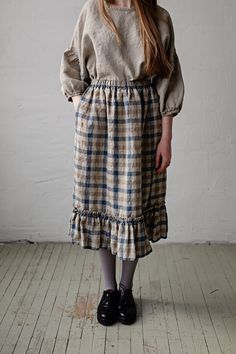 Victorian style inspired ruffle petticoat skirt is made from 100% soft and washed linen. This Petticoat is perfect for wearing under dress or other skirt or can be worn alone. Match it with our tunics! Details: - Composition: 100% Oeko-Tex certified linen - Colour: Natural/brown/Blue plaid - Pockets - Elastic waist - Size: One size/fits all - Medium weight linen - Linen care: machine wash gentle; tumble dry low, ironing optional - The price is for one skirt, other pictured items are not included Peasant Style Flowy Skirt With Ruffles, Fitted Peasant Skirt With Lining, Vintage Long Gathered Skirt, Vintage Long Gathered Skirt Bottoms, Cottagecore Long Skirt With Ruffles, Fitted Skirt For Gatherings, Vintage Tiered Skirt For Fall, Ruffled Midi Skirt For Fall, Fall Ruffled Midi Skirt