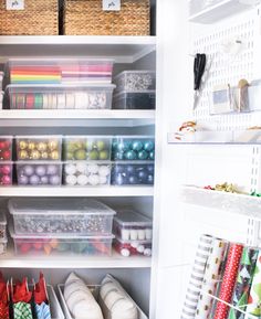 an organized pantry with lots of craft supplies and storage bins on the bottom shelf