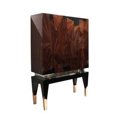 an art deco cabinet with metal legs and wood panels on the front, in black lacquer