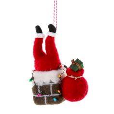 a christmas ornament hanging from a string with santa's hat and gloves on it