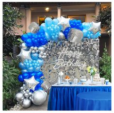 a blue and silver birthday party with balloons