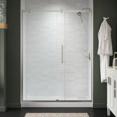 a walk in shower sitting next to a white sink