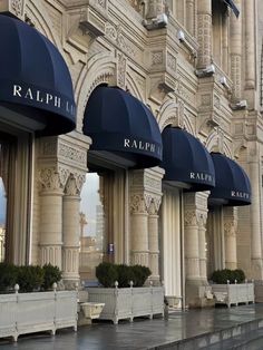 the facade of a building with blue awnings