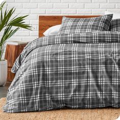 a black and white plaid comforter set on a bed