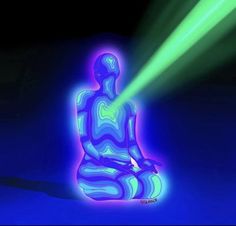 a person sitting in the middle of a room with green and blue light coming from behind