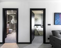 a living room filled with furniture next to a bedroom and bathroom area in a house