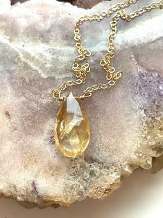 Just like the sun, with its glowing yellow color this handcrafted faceted tear drop citrine pendant necklace is a lovely piece for wearing alone or layering for a stunning statement. The organic and natural variations in this stone’s shape and color are what gives this necklace a true head-turning look. Considered a stone of joy, luck and happiness, feel the warmth and comfort.This citrine necklace will complete your wardrobe and bringing sunshine on any day. Perfect gift for someone you love 🌞 Faceted Citrine Amber Jewelry, Faceted Citrine Pendant Jewelry, Gold Drop Crystal Necklace With Gemstone, Gold Faceted Drop Necklace, Spiritual Teardrop Faceted Necklace, Amber Drop Gemstone Necklace, Gold Teardrop Gemstone Crystal Necklace, Citrine Briolette Beads For Jewelry Making, Amber Teardrop Birthstone Jewelry