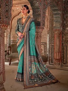 Elevate your festive and wedding wardrobe with this stunning Aqua Green Silk Saree. Featuring intricate Rajwadi print and shimmering Dew Drop work, this saree is a masterpiece of elegance and cultural finesse. Paired with a contrasting Deep Blue silk blouse, it ensures a regal look for special occasions. Versatility in Shades and Fabrics:The Aqua Green hue offers a refreshing and vibrant look, ideal for daytime events, while the luxurious silk fabric with an Aqua finish gives a rich, lustrous dr Green Silk Saree, Bold Gold Jewelry, Designer Silk Saree, Blue Silk Blouse, India Saree, Wedding Wardrobe, Sleek Updo, Nude Makeup