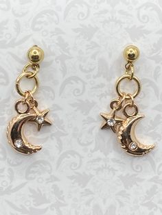 Moon and star charms the earlobe with a small crystal on each star and moon. Lots of movement! nickel free posts. Gold Moon-shaped Celestial Crystal Earrings, Celestial Gold Moon-shaped Crystal Earrings, Gold Celestial Crystal Earrings With Moon Charm, Gold Celestial Crystal Earrings Nickel-free, Gold Celestial Crystal Earrings Nickel Free, Celestial Gold Crystal Earrings Nickel Free, Gold Dangle Crystal Earrings With Moon Charm, Gold Star-shaped Crystal Earrings For Pierced Ears, Gold Star Earrings With Moon Charm