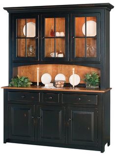 a black china cabinet with glass doors and candles on the top, in front of a white background