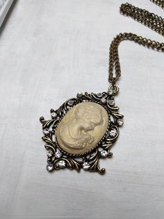 Vintage inspire cameo necklace made with antique gold brass findings and a shimmering resin cameo. Chain length - 52 cm. Cameo height - 5.5 cm, width - 4 cm  victorian cameo pendant, victorian lady cameo necklace, Long Necklace, vintage wedding necklace, statement necklace, bridal necklace, victorian bride, Charm Necklace, Luxury Bling, ,Vintage Inspired, ivory pearl Necklace, Rhinestone Charm, Elegant Necklace, Romantic Necklace, Affordable Gifts, Affordable Present, Bohemian Jewelry, victorian Luxury Cameo Necklaces For Anniversary, Luxury Cameo Necklace For Formal Occasions, Luxury Elegant Cameo Necklace, Elegant Luxury Cameo Necklace, Victorian Bride, Ivory Pearl Necklace, Victorian Cameo, Jewelry Victorian, Cameo Pendant Necklace