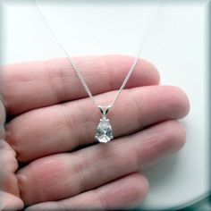 This sparkling pear shaped CZ pendant is a true stunner! Unusual shape and simple design. Cubic zirconia is a diamond alternative - wonderful for everyday wear and still get the sparkle without the cost. April's birthstone is a diamond and this would make a beautiful birthstone necklace. The pear shaped CZ pendant is 9x6 mm in size. Sterling silver setting and chain in your choice of length (see dropdown for options). Cubic zirconia is a synthesized (man-made) crystalline material that is hard a Cubic Zirconia Solitaire Necklace With Brilliant Cut Teardrop, Drop Solitaire Necklace With Diamond Cut Cubic Zirconia, Cubic Zirconia Solitaire Drop Necklace, Teardrop Brilliant Cut Cubic Zirconia Solitaire Necklace, Brilliant Cut Cubic Zirconia Teardrop Necklace, Teardrop Solitaire Necklace With Brilliant Cut Cubic Zirconia, Teardrop Cubic Zirconia Solitaire Necklace With Diamond Cut, White Teardrop Solitaire Necklace In Cubic Zirconia, White Teardrop Cubic Zirconia Solitaire Necklace