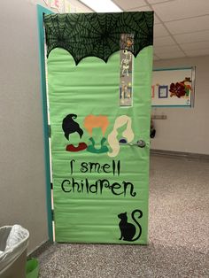 a green door with the words i smell children written on it