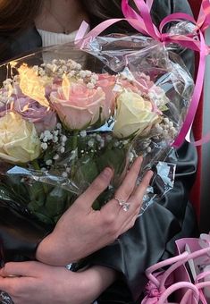 a woman is holding a bouquet of roses