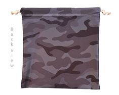 a brown and black camo print bag hanging from a hook on a white background