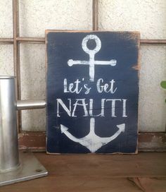 a sign that says let's get nauti and an anchor