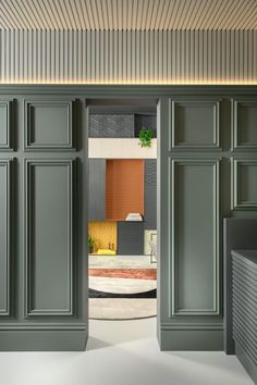 an open door leading into a room with green cabinets