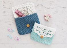 two crocheted purses sitting next to each other on a white wooden surface