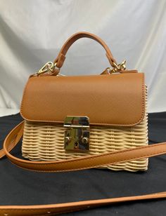 Trendy straw purse with tan leather details that can be styled with anything! Use as a handbag or crossbody! Brown Crossbody Shoulder Bag With Bamboo Handle, Top Handle Straw Bag With Leather Trim For Travel, Travel Straw Bag With Leather Trim And Top Handle, Rectangular Straw Bag With Leather Trim For Vacation, Rectangular Natural Satchel With Leather Trim, Natural Rectangular Satchel With Leather Trim, Spring Leather Straw Bag With Bamboo Handle, Chic Straw Bag With Bamboo Handle For Everyday, Beige Straw Bag With Leather Trim For Travel